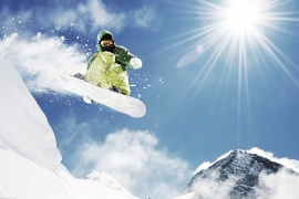 Snowboarder at jump inhigh mountains