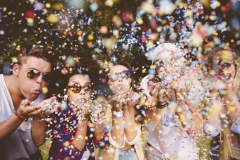 Hipsters blowing confetti