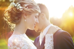 Young wedding couple on summer meadow